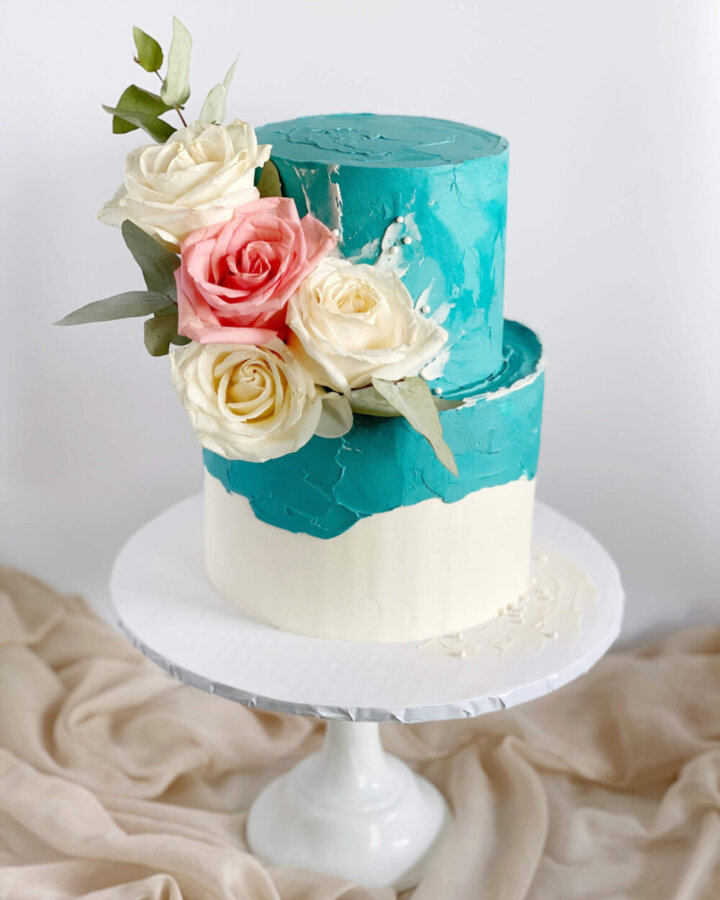 Teal buttercream cake with fresh flowers