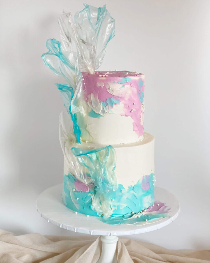 Frozen inspired cake. Rice paper sails and textured buttercream.