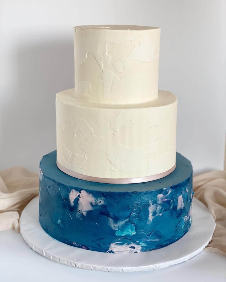 Blue, white, and mauve wedding cake with textured buttercream