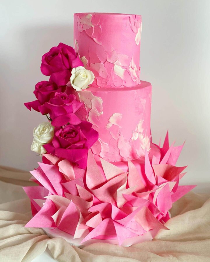 Pink Sweet 16 cake with wafer paper ruffles and flowers. Textured buttercream