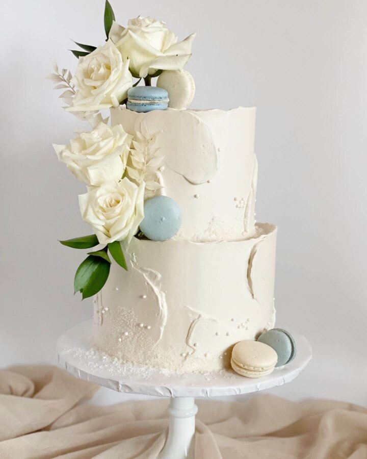 White and baby blue baby shower cake with macarons and flowers